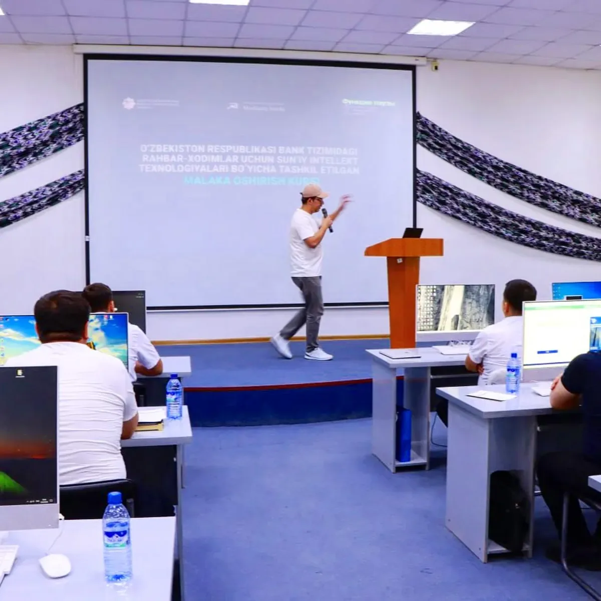 Yusuf presenting to a classroom of bank managers